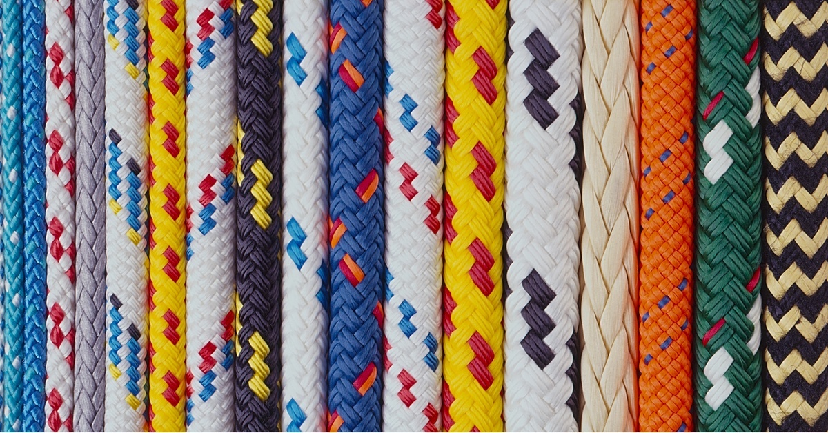 A collection of ropes in various colors and patterns laid out side by side in a vertical arrangement.